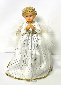 an angel figurine with white feathers and gold trimmings on its head