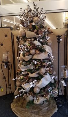 a christmas tree decorated with silver and white ornaments