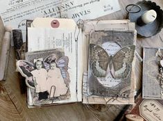 an open book with altered images on it and some other items surrounding it, including a pair of scissors