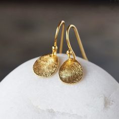 Gorgeous, curved teardrops of gold vermeil feature a shiny, brushed finish and hang from simple gold vermeil ear wires. These earrings glint and sparkle with your movements and work equally well for everyday or special occasions. The teardrops measure 14mm long and the entire earring measures just under one inch from the top of the ear wire to the bottom of the drop. Feminine Closet, Gold Teardrop Earrings, Earrings Everyday, Sparkle Earrings, Brushed Metal, Metal Earrings, Wedding Earrings, Ear Wire, Teardrop Earrings