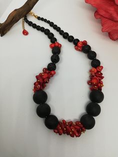 Beautiful handmade necklace with red coral chips (5 - 6 mm), matte obsidian beads and black lava stone. The necklace is 43 cm long, is a crew neck and has an adjustable golden steel clasp. The coral chips were fixed with gold tacks. The necklace is very elegant, very beautiful in summer with a low-cut dress. It recalls the sea, the sun... for those who love nature. A beautiful gift for her. All jewels are delivered in a decorated box, ready to be given as a gift to your loved one. How to take care of your jewellery: put on your beauty products (cosmetics, perfumes, ...) before wearing your precious jewel. Clean your jewelry with a soft cloth after wearing. Don't use water. Make sure you store your jewelry separately to avoid scratching it. Store away from heat sources, in a dry place in th Lava Stone Necklace With Natural Stones For Gift, Black Lava Stone Necklace For Gift, Adjustable Red Necklace With Black Beads, Black Lava Stone Round Bead Necklaces, Unique Red Necklace With Black Beads, Black Gemstone Necklace, Unique Red Multi-strand Beaded Necklace, Elegant Multi-strand Red Coral Beaded Necklaces, Lava Stone Necklace