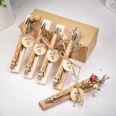 six wooden pens with writing on them are tied up and placed next to each other