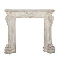 a white marble fireplace mantel with carvings