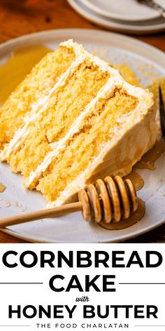 a close up of a piece of cake on a plate with a fork and honey