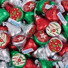 assorted herse kisses with christmas tree decorations on them, all wrapped in foil