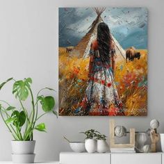 A young Native American woman stands gracefully amidst the golden prairie, her flowing dress adorned with vibrant red and blue accents that mirror the colorful wildflowers around her. Before her, a buffalo roams, symbolic of strength and survival, while a solitary teepee rises in the distance, a haven amidst the vast, open land. The textured brushstrokes bring to life the swirling winds of the plains, capturing the essence of freedom and connection to the earth. This canvas encapsulates the deep spiritual bond between Native American culture and the majestic landscape they call home. Majestic Landscape, Colorful Wildflowers, Native American Woman, Flowing Dress, Flowing Dresses, American Culture, American Woman, Native American Culture, Woman Standing