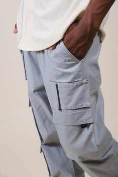 Stay up to date with all the fashion fads and bring Y2K styles back to your wardrobe with our Multi-Pocket Poplin Cargo Pant. Whether you work a blue-collar job or just love the aesthetic, a utilitarian and versatile cargo pant is a must-have staple for any streetwear-loving man. Grab a pair and unlock the limitless style options men’s cargo pants offer. Designed with one of our high-quality fabric blends to keep you comfortable with every wear, this pair of pants will keep you feeling and looki Midweight Nylon Cargo Pants With Functional Pockets, Non-stretch Bottoms With Cargo Pockets For Streetwear, Relaxed Fit Five-pocket Pants For Streetwear, Outdoor Full-length Cargo Pants With Patch Pockets, Cargo Pants Sale, Military Nylon Cargo Pants With Cargo Pockets, Cargo Pant, Y2k Style, Pair Of Pants