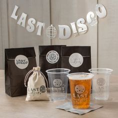 plastic cups and bags on a table with the words last diso written above them