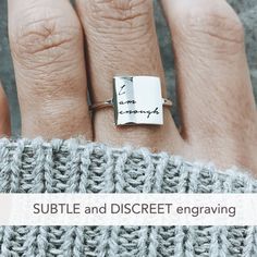 Sterling Silver I Am Enough Statement Ring Have faith in yourself! This subtle, discreet message reminds you that no matter what others say, just remember: 'I AM ENOUGH'. ✅ PRODUCT DETAILS * Material: solid sterling silver. * Square size is 10 x 10 mm and 1.3mm thick. * We use US ring size (please refer to the last picture of the product for the instruction to find your correct US size). ✅ PRODUCTION & SHIPPING INFO 📌 Important: please be aware that the shipping time does not include the pr Meaningful Sterling Silver Promise Ring Engraved, Meaningful Engraved Sterling Silver Promise Ring, Engraved Meaningful Promise Rings, Meaningful Stamped Engraved Promise Ring, Engraved Text Anniversary Rings, Meaningful Sterling Silver Promise Ring, Meaningful Promise Ring With Engraving Option, Meaningful Engraved Promise Ring With Engraving Option, Meaningful Engraved Ring For Promise