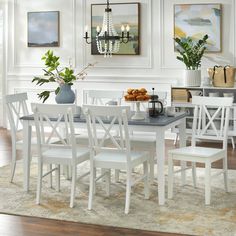 a dining room table and chairs with white walls