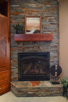 a living room with a fire place and a painting on the wall