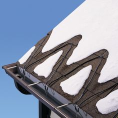 the roof is covered with snow and wires