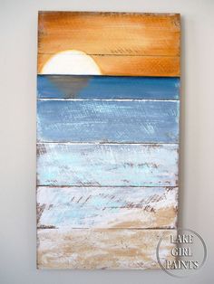 the painting is hanging on the wall with white paint and wood planks, it looks like an ocean sunset