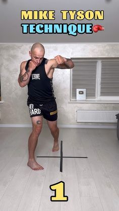 a man standing on top of a wooden floor in front of a sign that says mike tyson technique 1