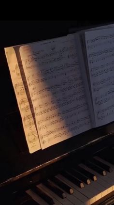 an open book sitting on top of a piano