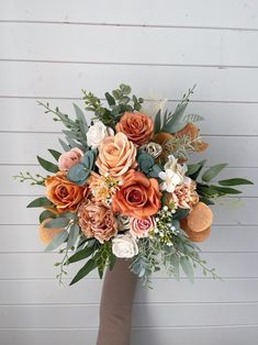 a bridal bouquet with orange and white flowers