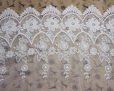 an image of white lace on fabric