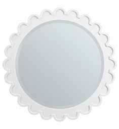 a round mirror with scalloped edges on a white background