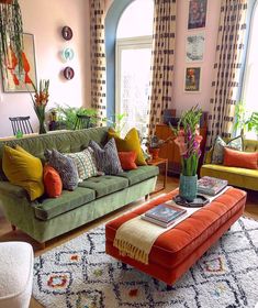 a living room filled with lots of furniture and flowers on top of a coffee table