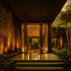 an entrance to a house with steps leading up to it and plants on either side