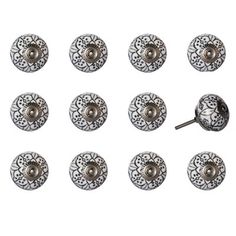 six pairs of metal knobs with ornate designs