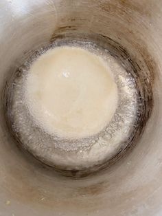 the inside of a metal bowl filled with liquid