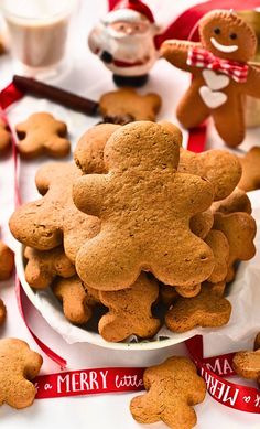 there is a bowl full of cookies on the table next to other christmas treats and decorations