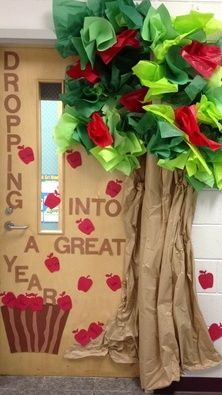 a classroom door decorated with paper flowers and cupcakes for valentine's day