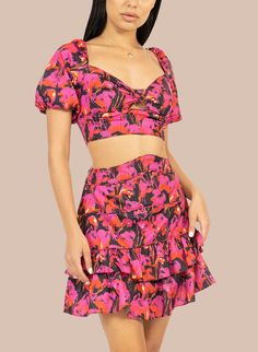 The Celia 2-Piece Candy Set will have you showing up with style and attitude. Influenced by style of numerous American immigrant cultures, this breezy matching fun printset featuring a cropped top with puff sleeves and a criss-crossed tie back, and a tired flare skirt to finish the sweet yet sassy style. Material: Polyester Hand Wash, Cool iron Sold as a set Fitted Two-piece Top For Spring, Summer Two-piece Mini Length Crop Top, Summer Two-piece Crop Top, Pink Two-piece Tops For Summer, Summer Two-piece Crop Top Set, Fitted Summer Sets In Mini Length, Printed Fitted Crop Top For Summer, Casual Fitted Sets With Ruffles, Fitted Casual Sets With Ruffles