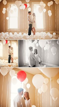 two people standing next to each other in front of balloons