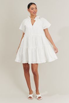 Weather you’re looking for something casual or cute, the Pallas Poplin Tiered Mini Dress will suit you perfectly! This mini dress has ruffle tiers all along a loose fit style. A split neckline with a self-tie neck makes it easy to style. Add on your sandals or heels to this cute dress! - Tiered- Ruffles- V-neck- Tie neck- Comes in 2 colorsSize + Fit - Model is 5'8" and wearing size XS- Measurements taken from size S - Chest: 20 3/4"- Length: 35" Fabric Self: 100% Cotton, Lining: 97% Polyester, 3 White V-neck Tiered Casual Dress, White Tiered Dress With Layered Hem, White Ruffle Hem Tiered Dress For Vacation, White Tiered Dress With Ruffle Hem, White Tiered Dress With Ruffle Hem For Vacation, Ruffled Mini Length Tiered Dress For Day Out, White Mini Length Tiered Dress With Ruffles, White V-neck Tiered Dress For Brunch, White Layered Hem Mini Dress For Spring