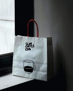 a paper bag with a coffee cup on it