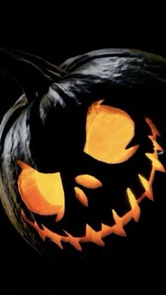 a carved pumpkin with glowing eyes on it