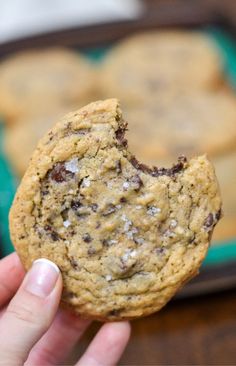 a person holding up a cookie in their hand