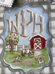 a glass plate with an image of a farm scene and the word north painted on it