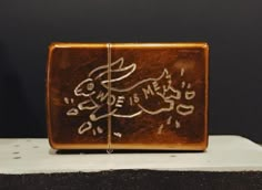 a small wooden box with writing on it