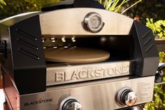 an outdoor grill with black stone on it