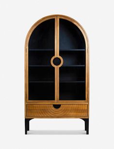 a wooden cabinet with black glass doors and an oval design on the front, against a white background