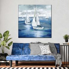 three sailboats floating in the ocean on a blue couch