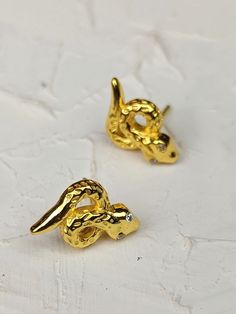 For someone who has multiple piercings, or just wants dainty size earrings, but still loves their snakes, these are the perfect little earrings. 18 kt gold over pure brass Zircon eyes Approximately .5" long and .5" wide Handmade in India with fair labor practices Each pair is one-of-a-kind and colors will vary slightly. Tiny Snake, Scale Texture, Multiple Piercings, Easy Shape, Rose Jewelry, Free Gift Wrapping, Fall Shopping, Snakes, Free Giveaway