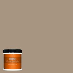 the behr paint color is shown in an orange hue, and it has a black lid