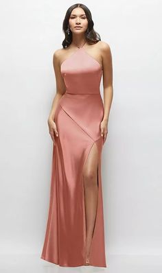 a woman in a long pink dress with slits on the side and one leg