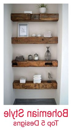 bathroom shelves made out of wood with pictures and towels on the ledges above them