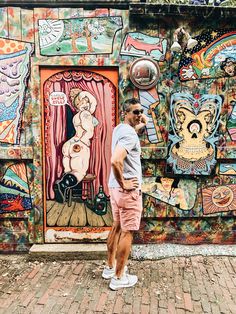 a man standing in front of a colorful wall