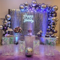 a purple and silver birthday party with balloons