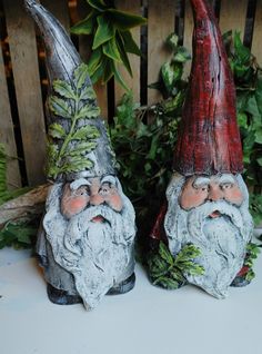 two garden gnomes sitting next to each other