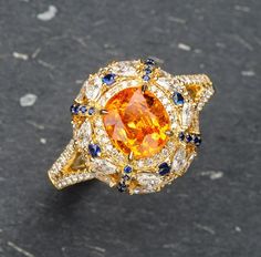 * Condition: Brand new * Center Stone: Natural Spessartite Fanta Garnet, Oval Brilliant cut, Approx 2.29ct * Side stones:  Natural White Diamond, Round-cut, Marquise cut (VVS clarity with F color) Natural Blue Sapphire, Round-cut * Two in one jewelry, can use on ring or pendant. * Metal Purity: 18k Solid Yellow Gold (optional) * Chain Length: 45cm (adjustable) * Free DHL Express Shipping. * Attached with Certificate.  * Each piece is made-to-order with care and special attention to detail.  all Luxury Yellow Gold Garnet Diamond Ring, Luxury Orange Jewelry With Yellow Sapphire, Luxury Orange Yellow Sapphire Jewelry, Luxury Orange Jewelry With Gemstone Accents, Luxury Orange Gemstone Accented Jewelry, Luxury Orange Gemstone Jewelry, Luxury Orange Oval Jewelry, Luxury Orange Jewelry For Anniversary, Luxury Yellow Sapphire Jewelry