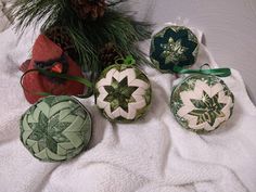 four ornaments are sitting on a white towel