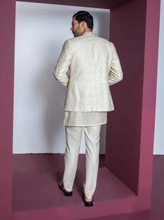 Drape yourself in sophistication with a shawl collar embroidery jacket, perfectly paired with a textured chanderi kurta and pants. This ensemble combines modern style with intricate detailing, creating a refined and effortlessly stylish look for various occasions. Elegant Chanderi Nehru Jacket With Traditional Drape, Elegant Nehru Jacket With Traditional Drape In Chanderi, Elegant Chanderi Nehru Jacket For Festive Occasions, Elegant White Chanderi Nehru Jacket, Elegant Cream Cotton Silk Traditional Wear, Cotton Silk Nehru Jacket For Wedding Long Sleeve, Formal Chanderi Bandhgala With Chikankari Embroidery, Long Sleeve Cotton Silk Nehru Jacket For Wedding, Elegant Chanderi Bandhgala For Wedding