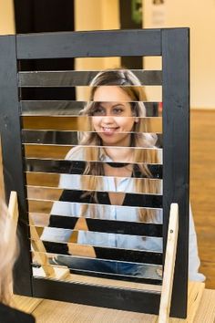 a woman is looking in the mirror with her reflection